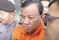 Bupati Kuantan Singingi, Suhardiman Amby, tampak mengenakan rompi oranye khas tahanan KPK saat didampingi petugas kepolisian usai menjalani pemeriksaan di Gedung Merah Putih KPK, Jakarta, Rabu (1/7/2026). Foto: Ist.